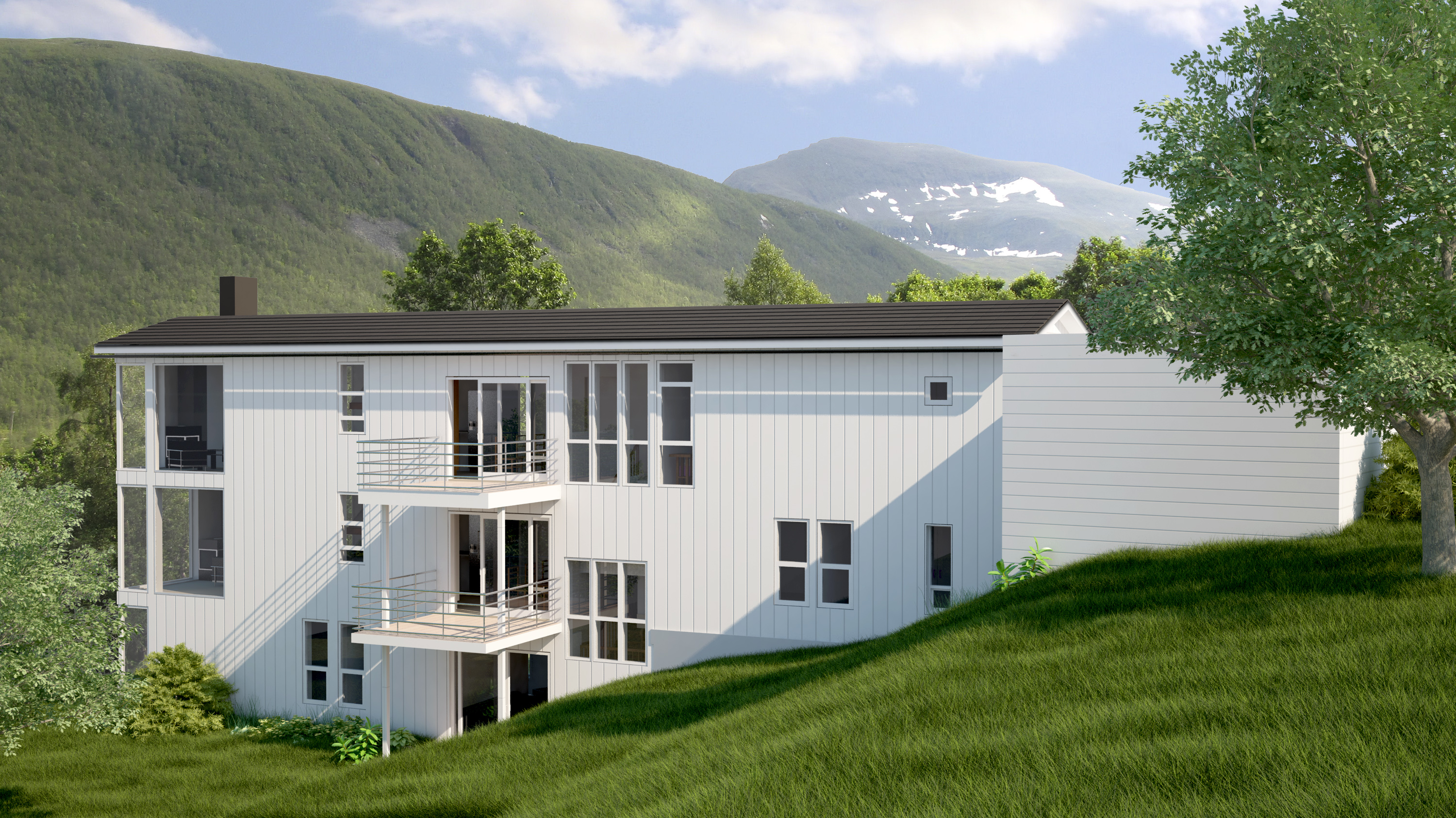 et hvitt hus i en grønn åsside.