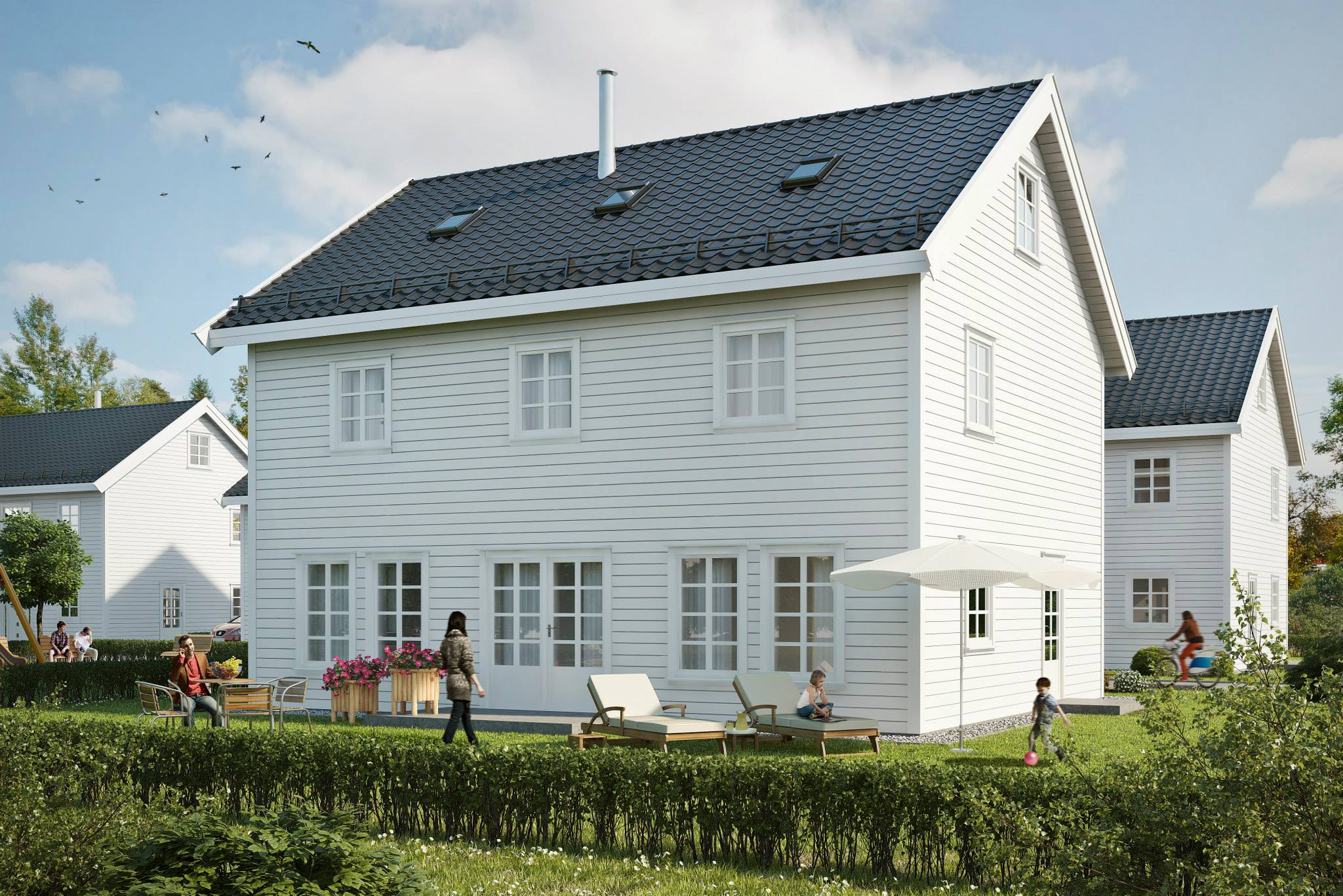 et hvitt hus med svart tak.