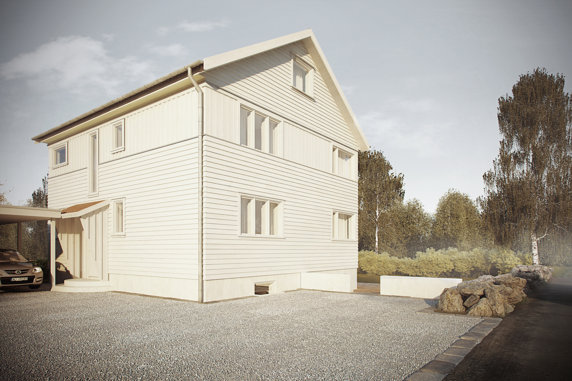et hvitt hus med en bil parkert foran.