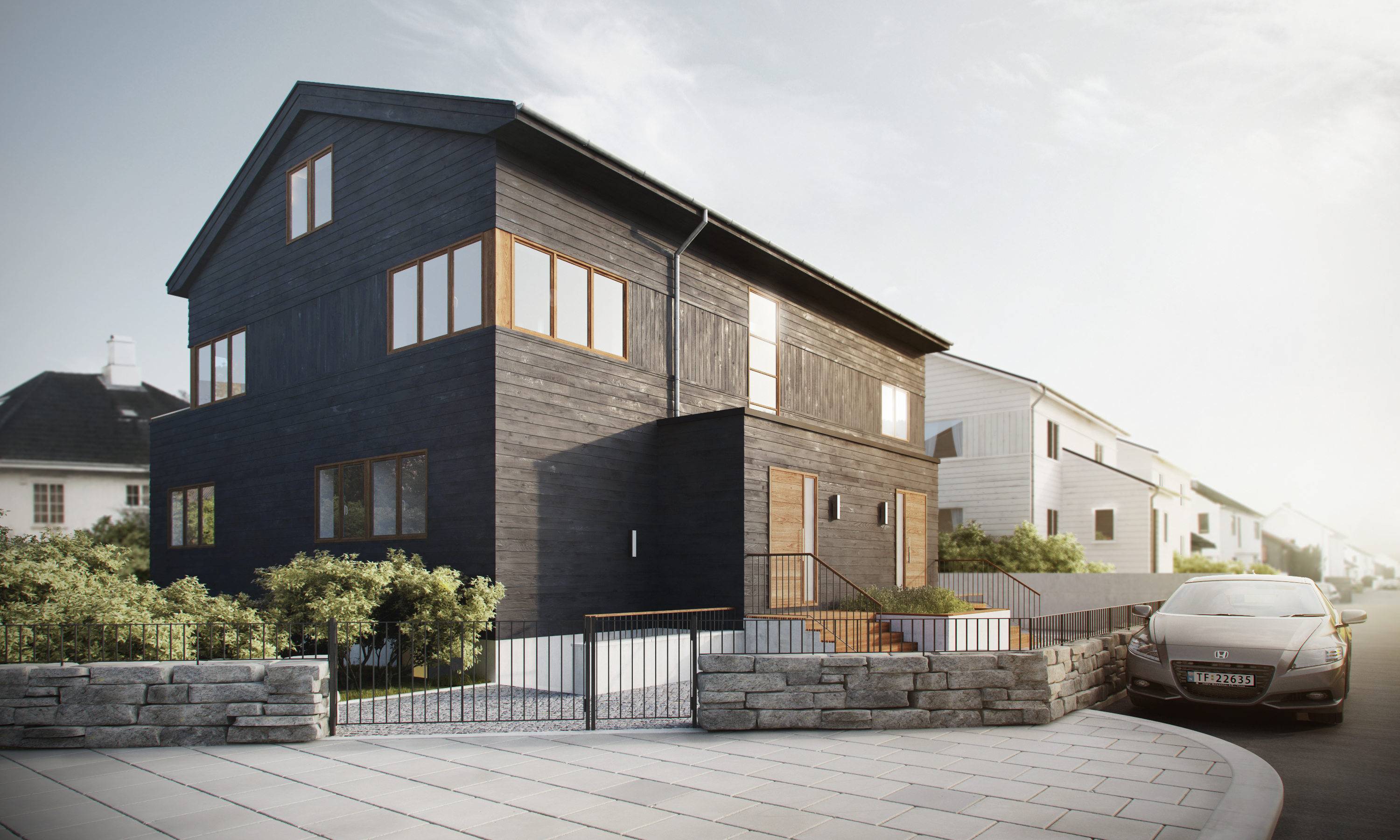 et svart hus med en bil parkert foran.