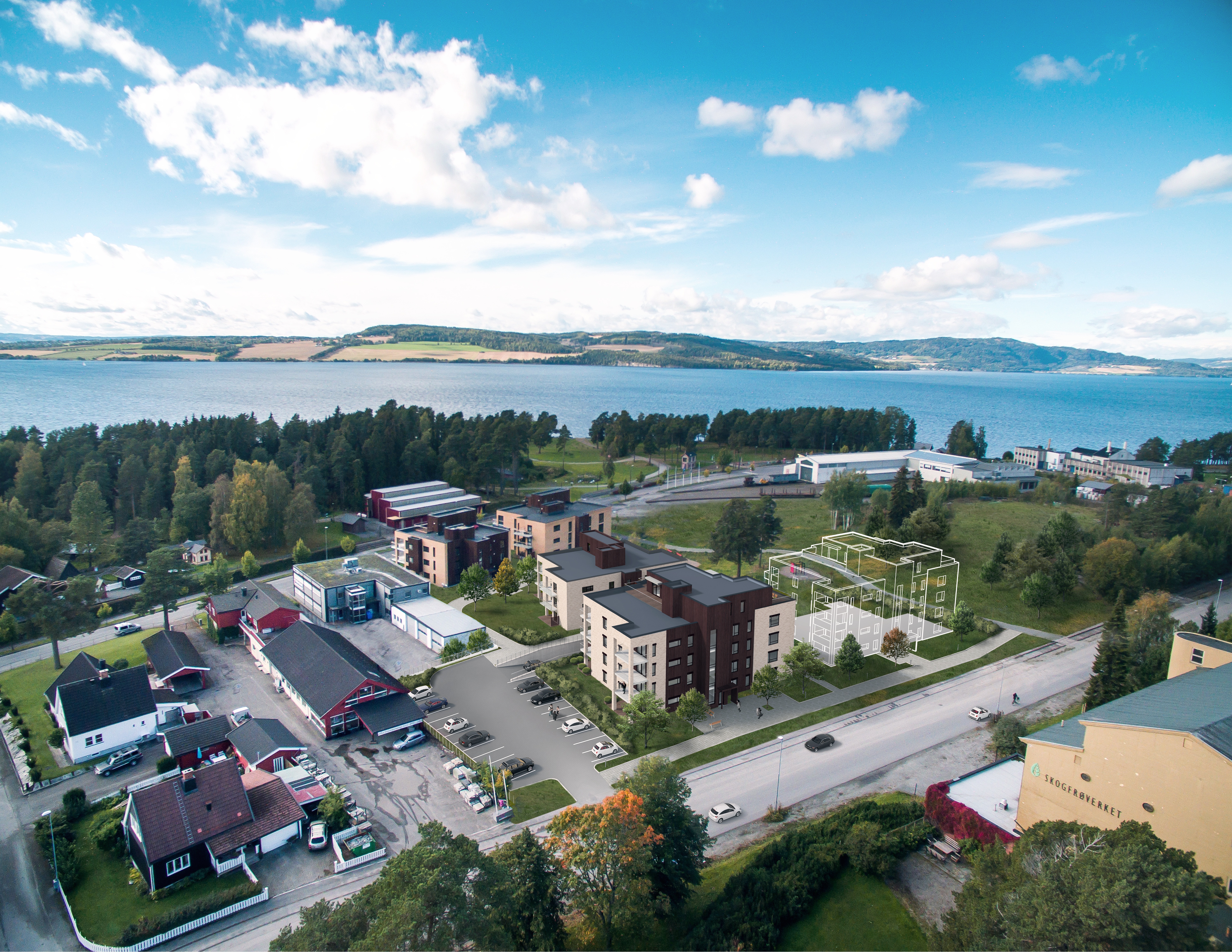 et luftfoto av et boligområde nær en innsjø.