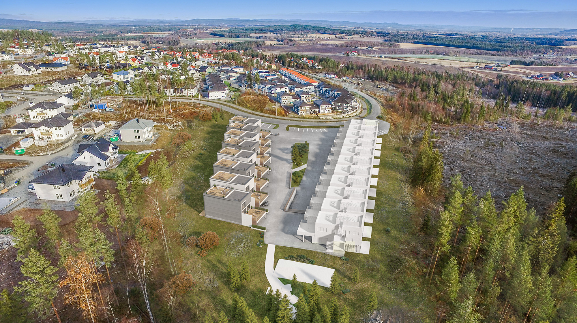 et luftfoto av et boligområde i en skog.