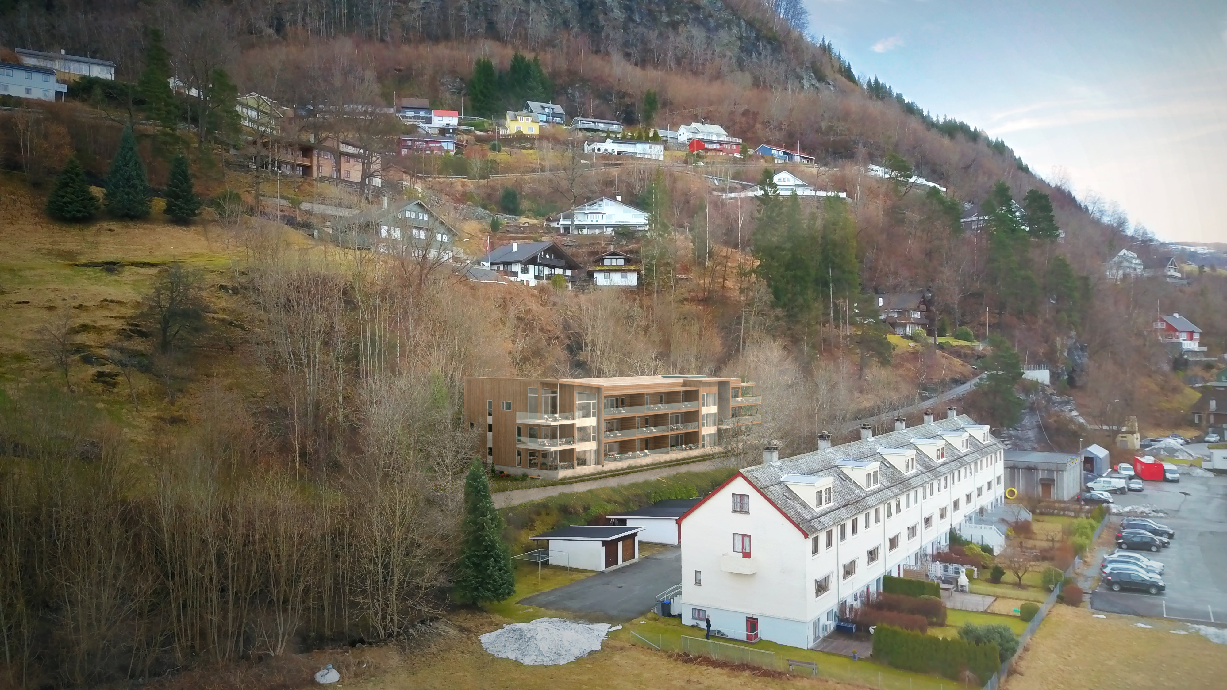 Visualisering for salg av en by med hus på fjellsiden.