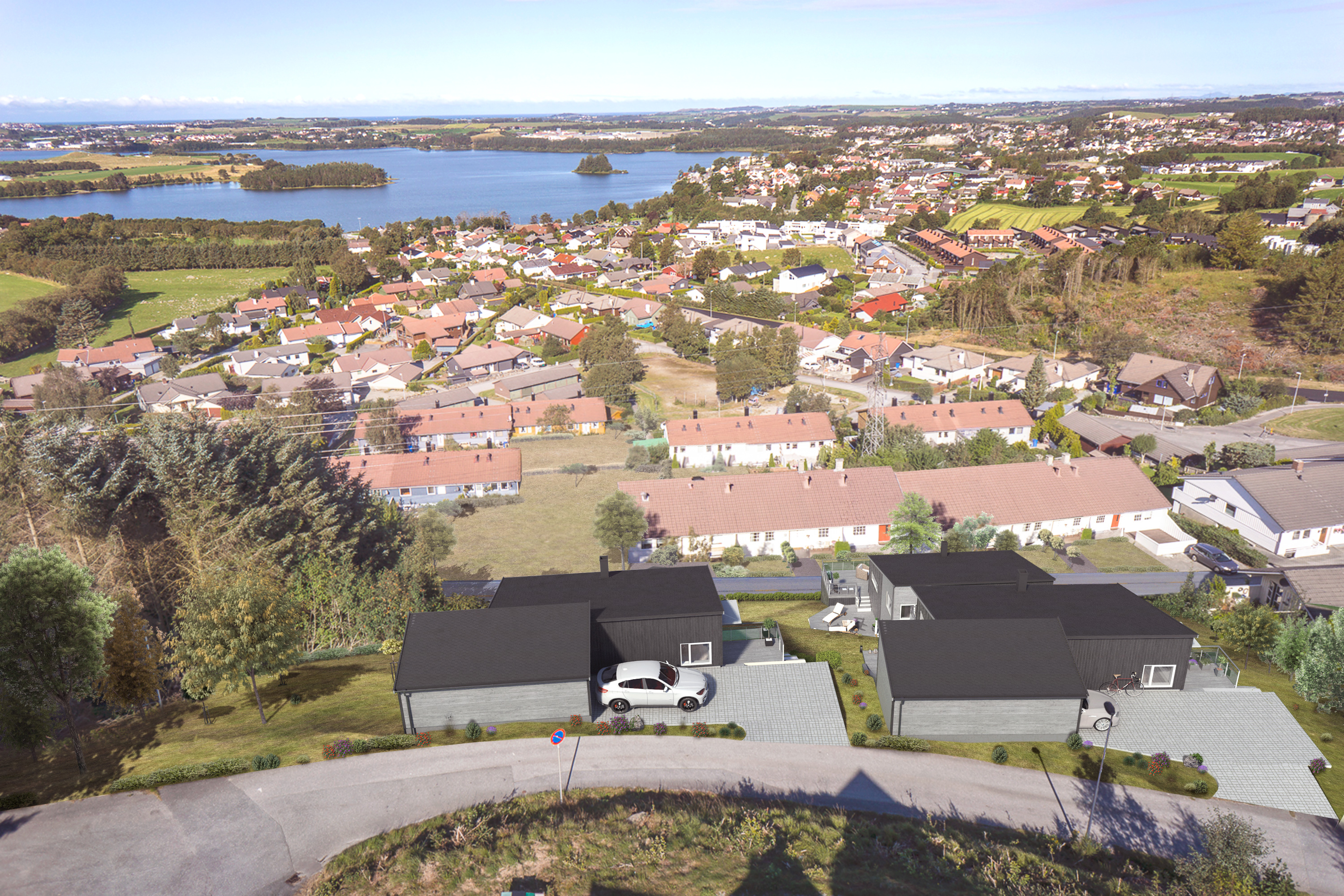 Et luftfoto av en by med hus og en innsjø for å visualisere hussalg i 2017.