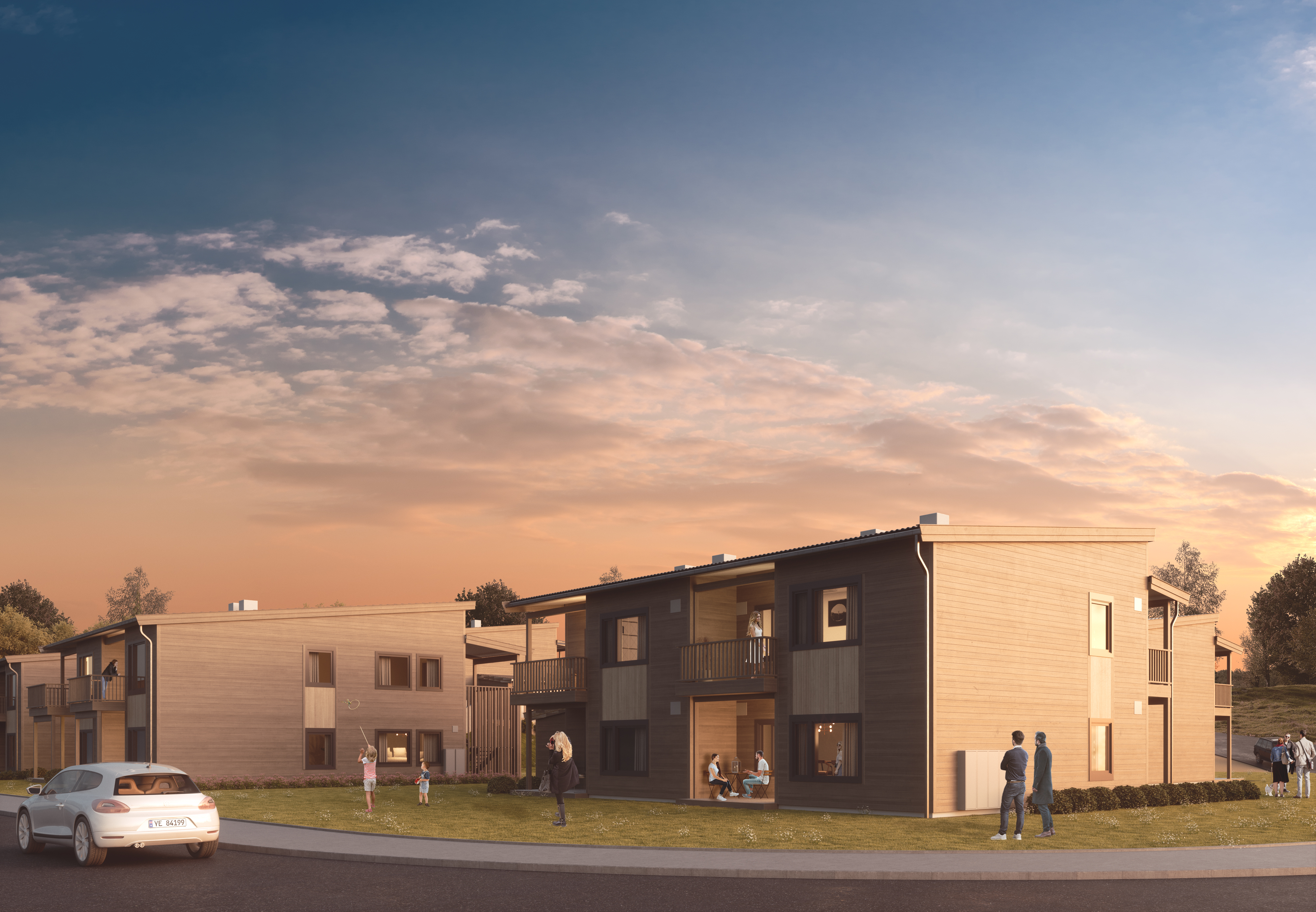 en kunstners gjengivelse av et leilighetskompleks ved solnedgang.