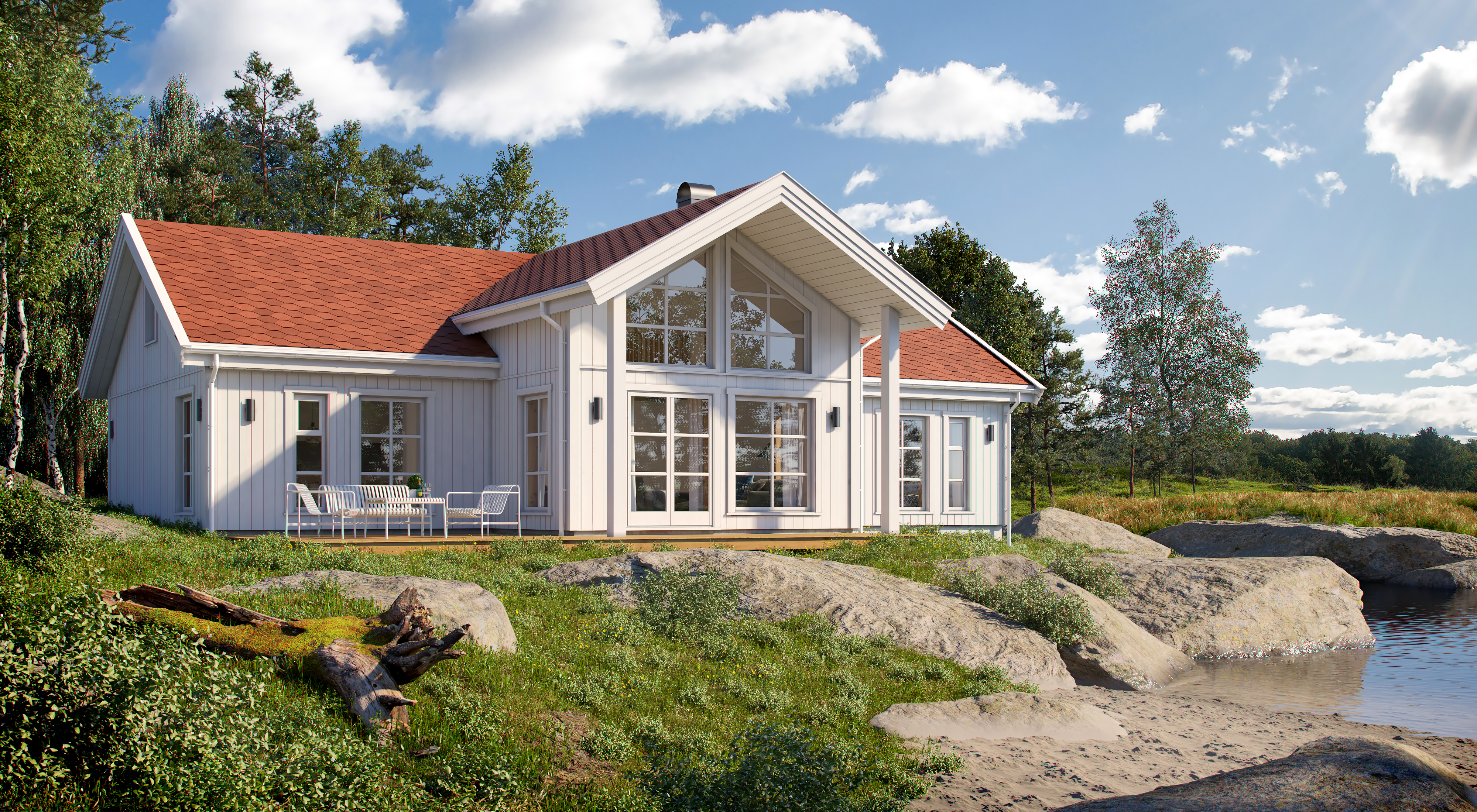 et hvitt hus med rødt tak ved siden av en vannmasse.