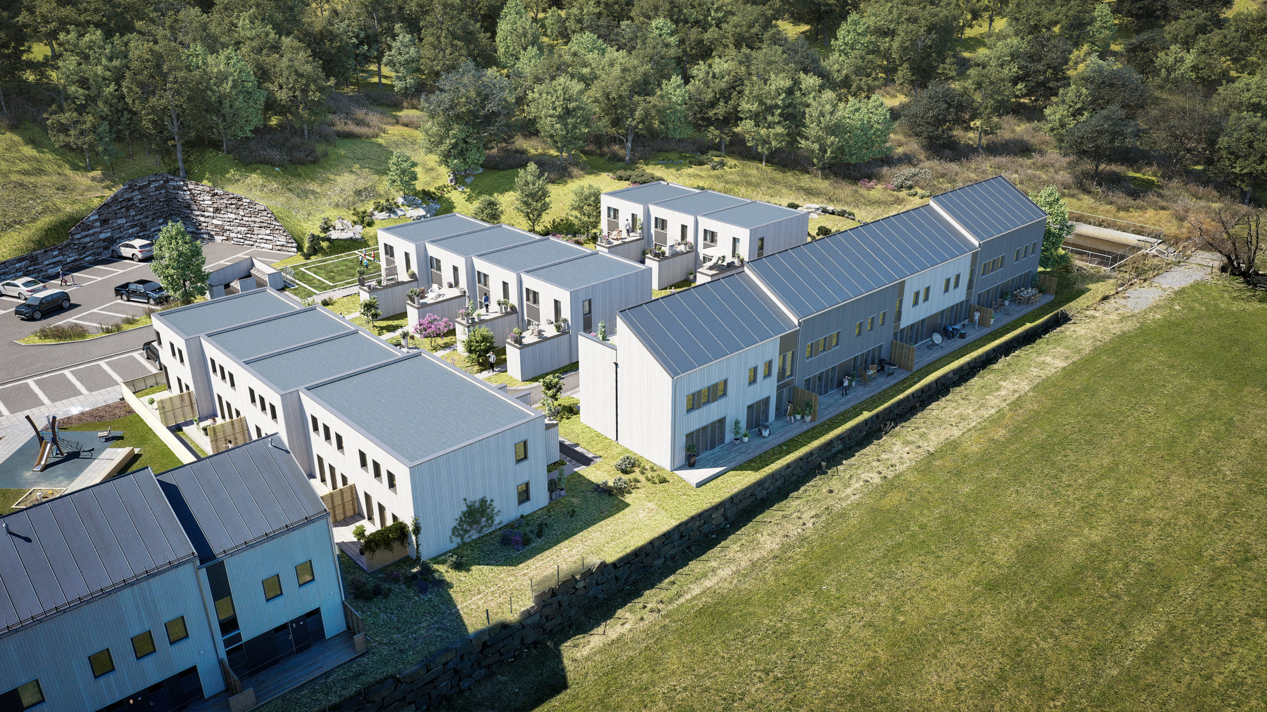 en luftfoto av et leilighetskompleks i et skogsområde.