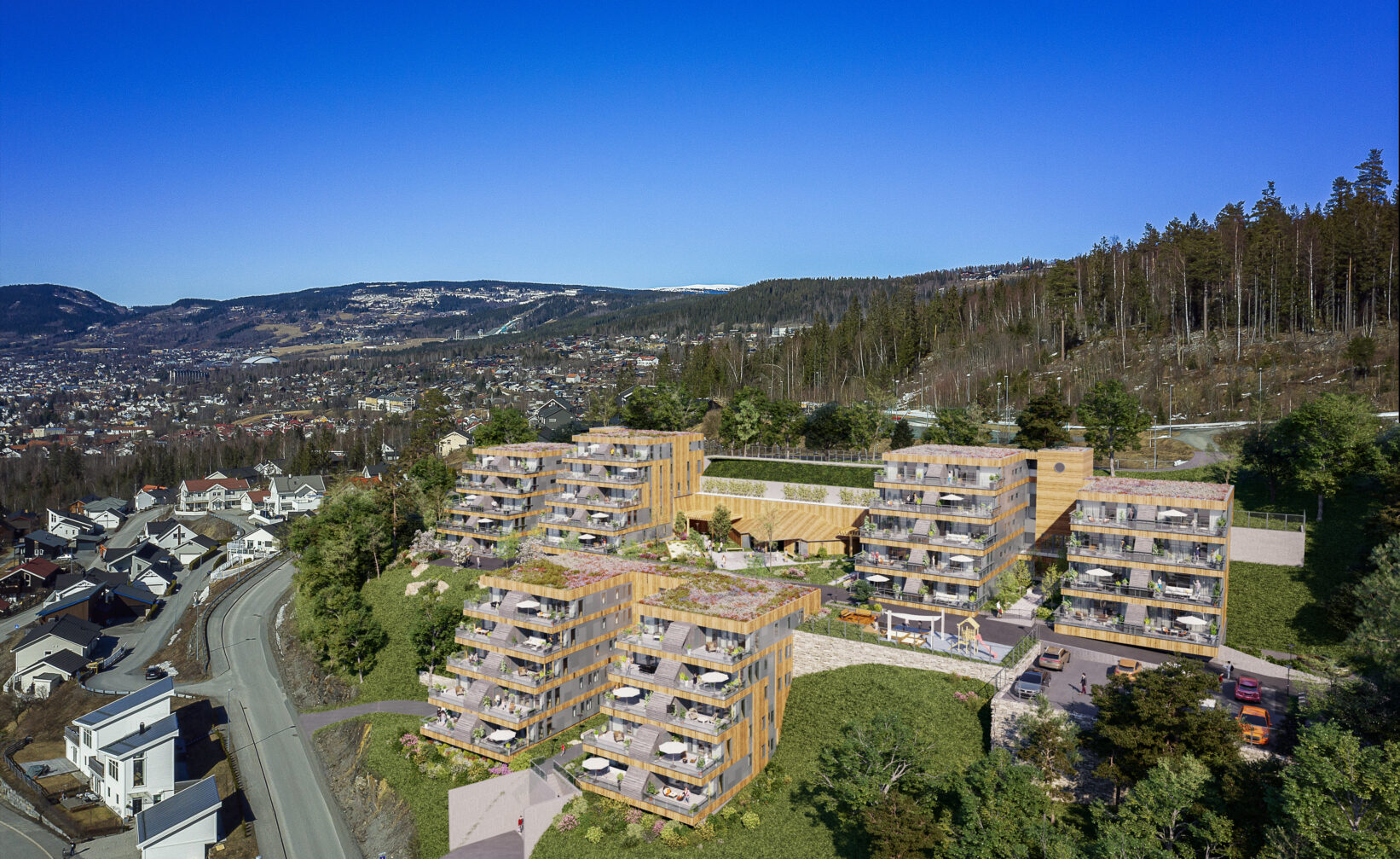 en luftfoto av et leilighetskompleks i fjellet.