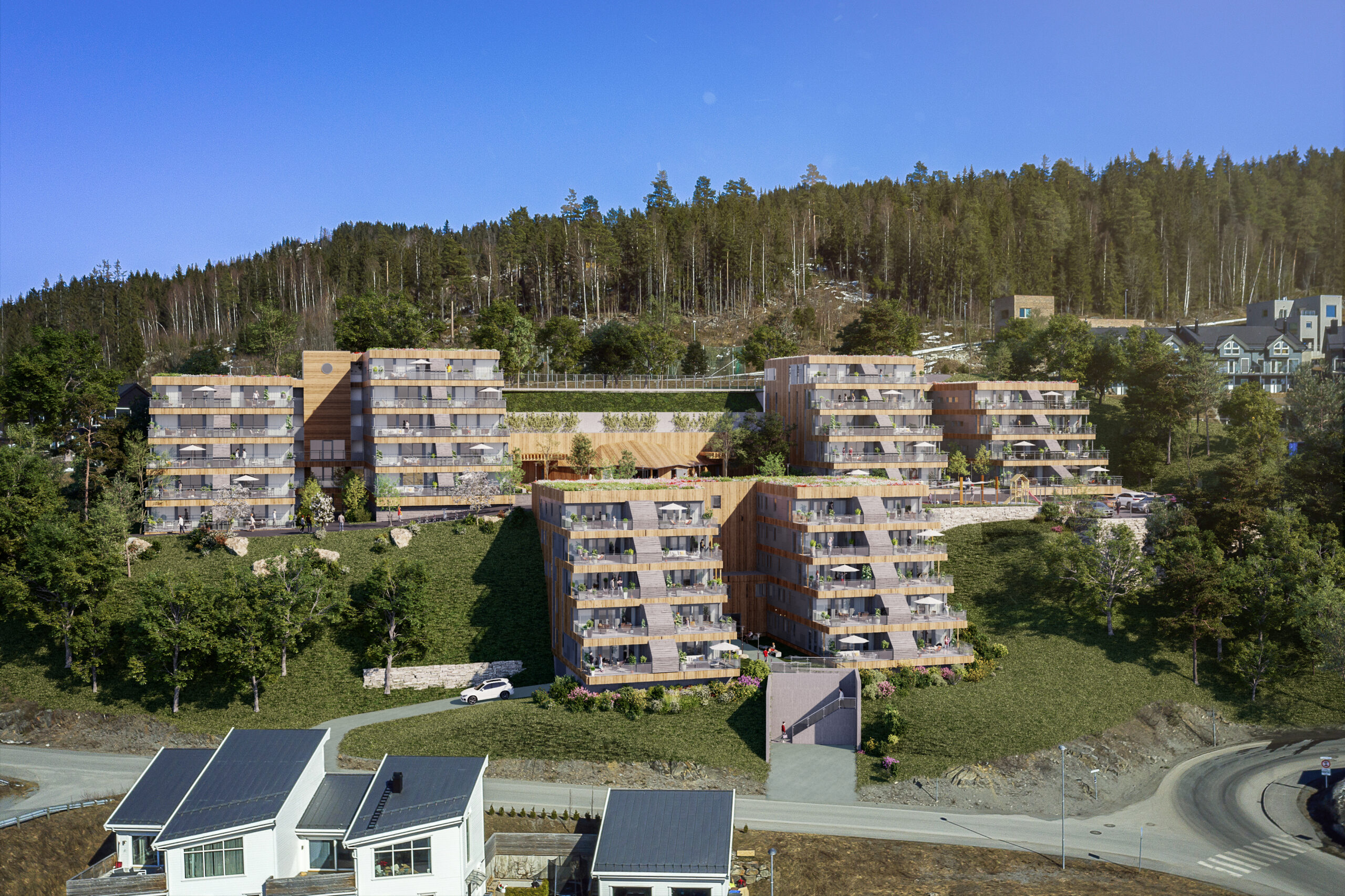 en luftfoto av et leilighetskompleks i en åsside.