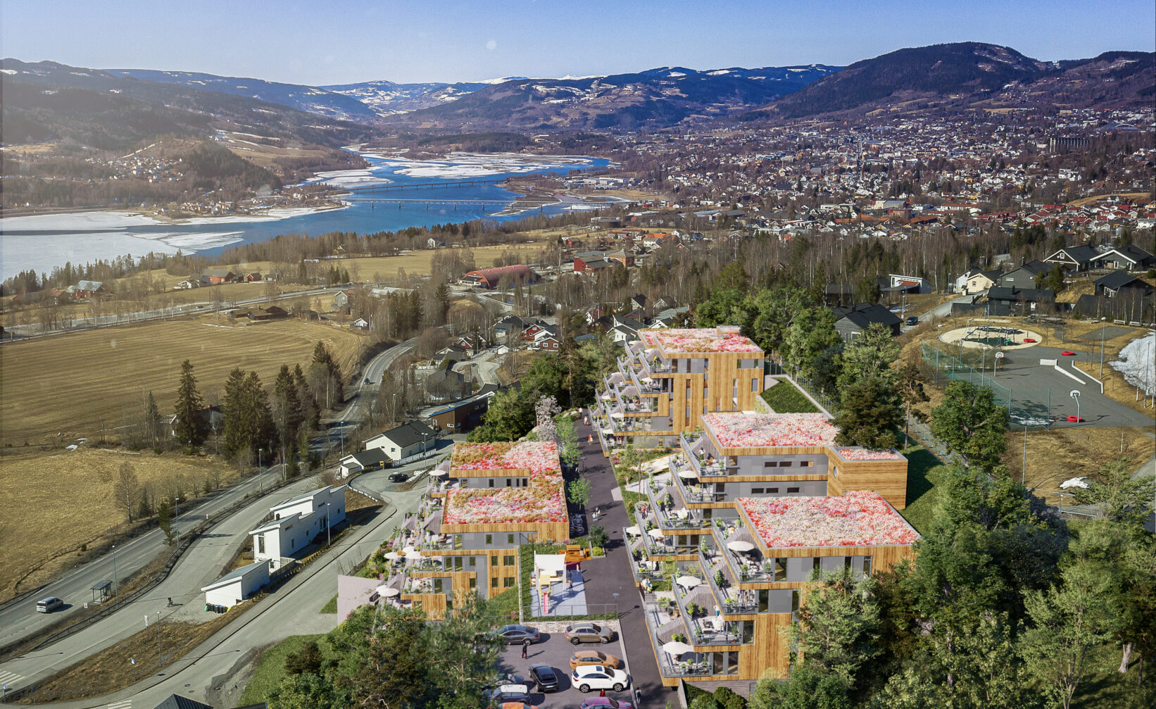 et luftfoto av et boligområde nær en innsjø.
