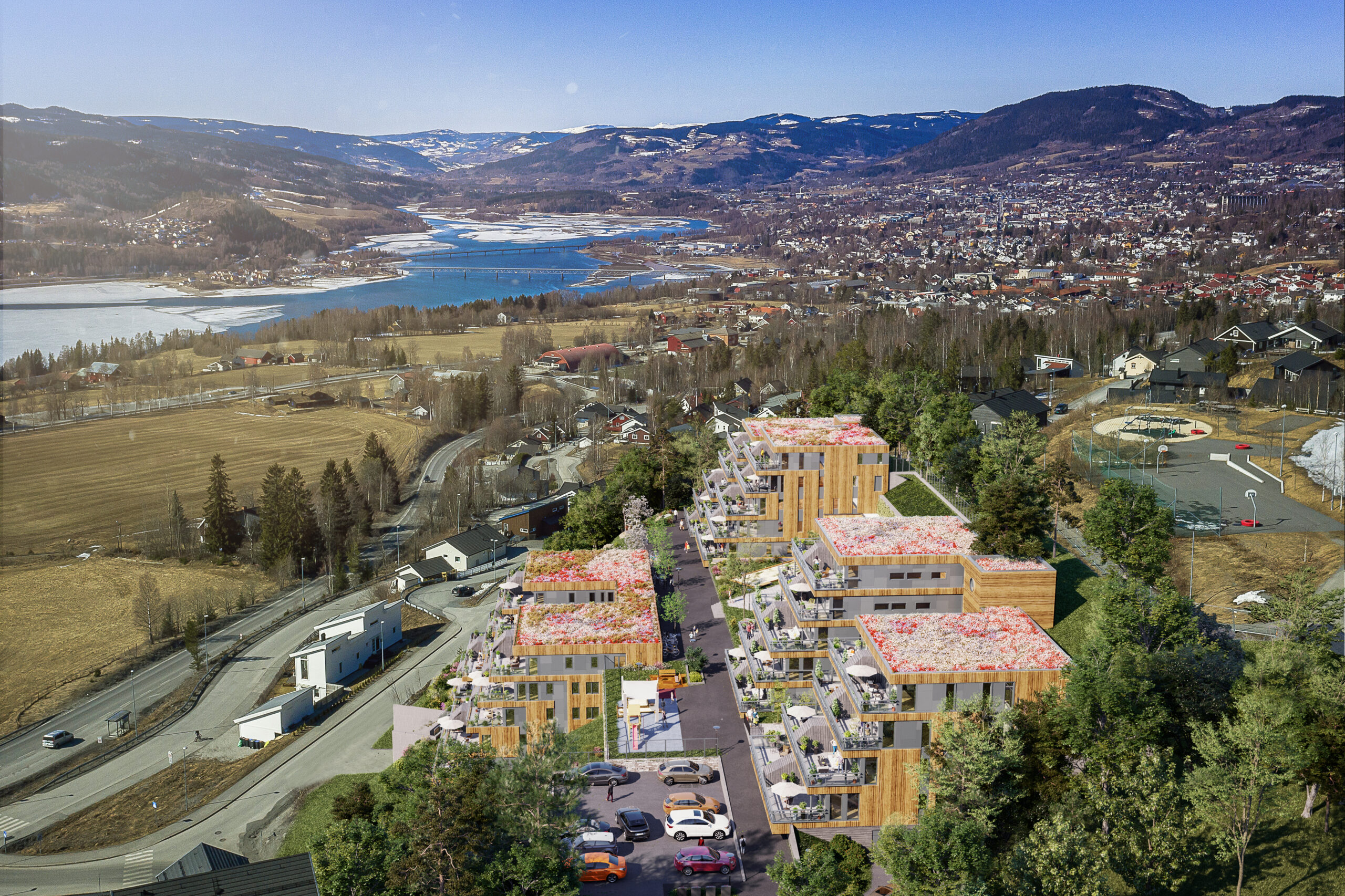 et luftfoto av et boligområde nær en innsjø.