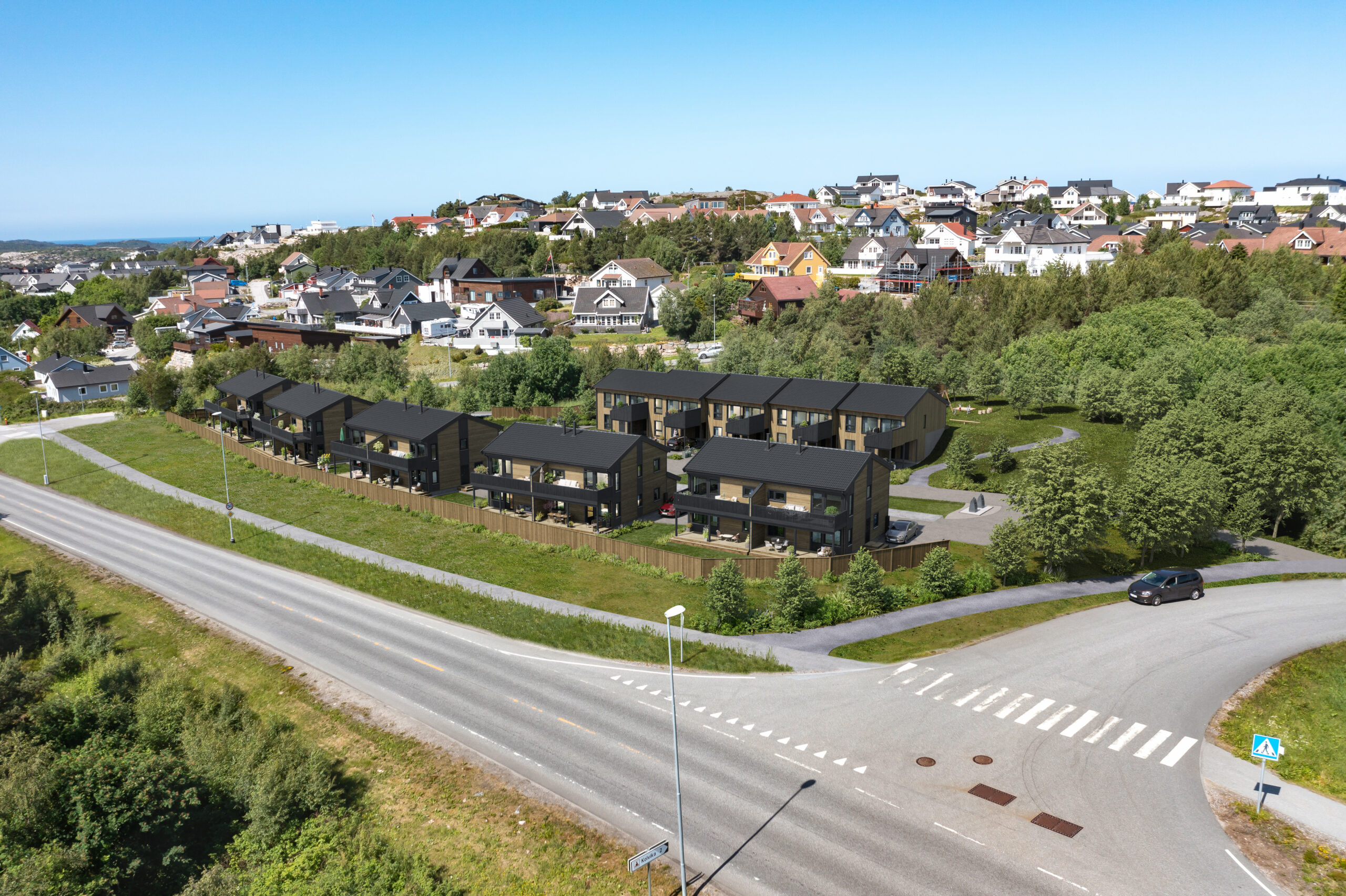 et luftfoto av en by med hus på siden av en vei.