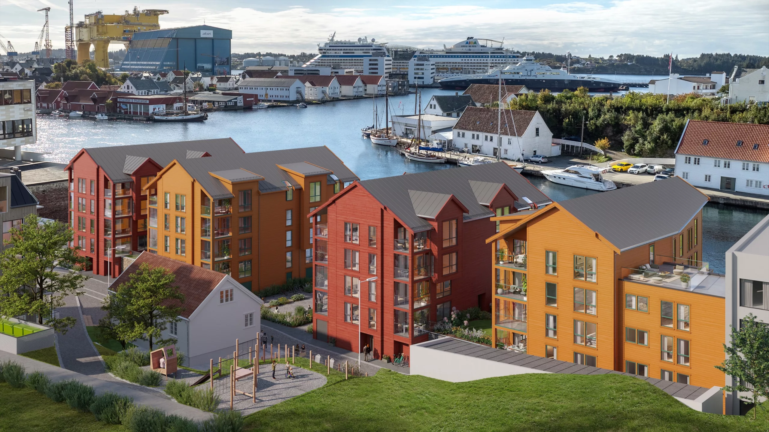 Fargerike bygårder nær en vannkant med skip og et verft i bakgrunnen under en delvis overskyet himmel.